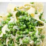 Close-up of pappardelle pasta with peas.