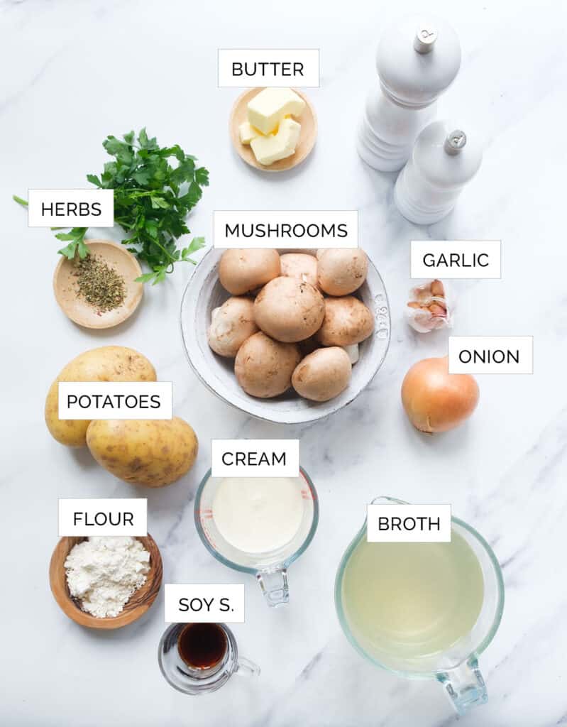 The ingredients to make this potato mushroom soup are arranged over a white background.