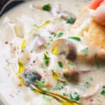 Close-up of a blue bowl full of creamy potato mushroom soup.