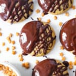 Top view of a few chocolate orange cookies over a white background.