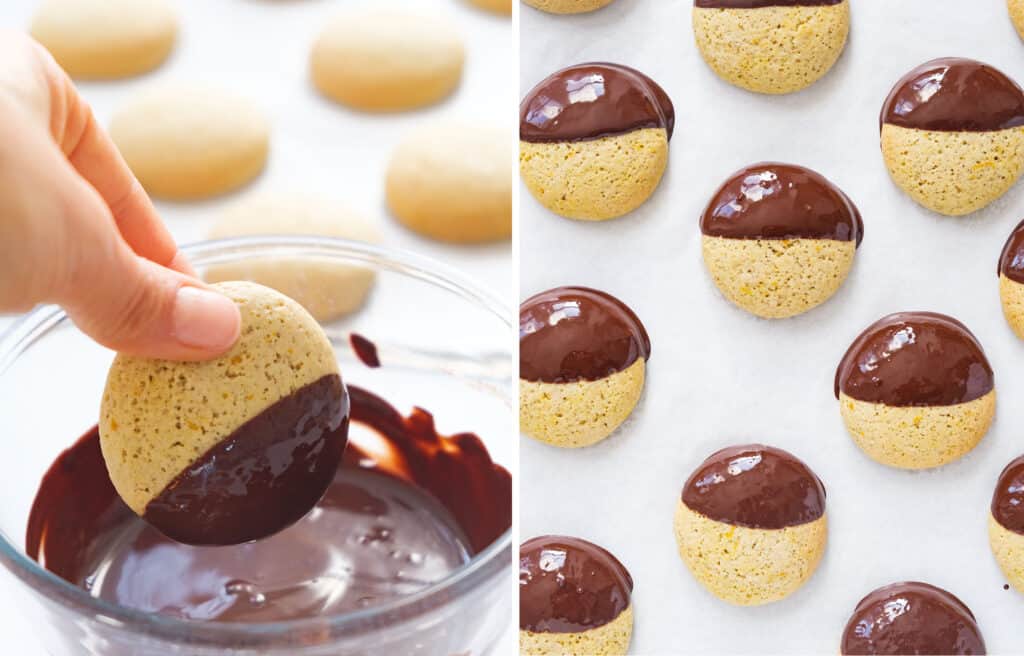 The orange cookies are dipped into a glass bowl full of melted chocolate.