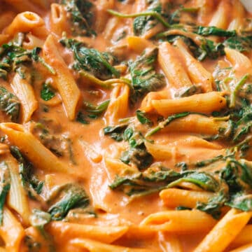 Close-up of one pf my fav penne pasta recipes made with tomato, spinach and cream cheese.