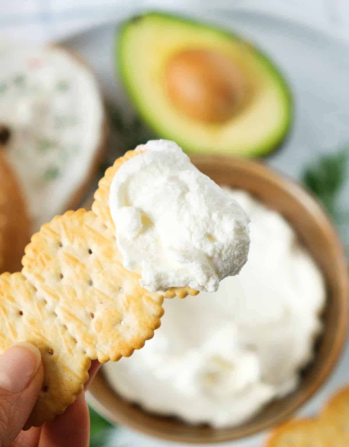 Close-up of a cracker with whipped cream cheese.