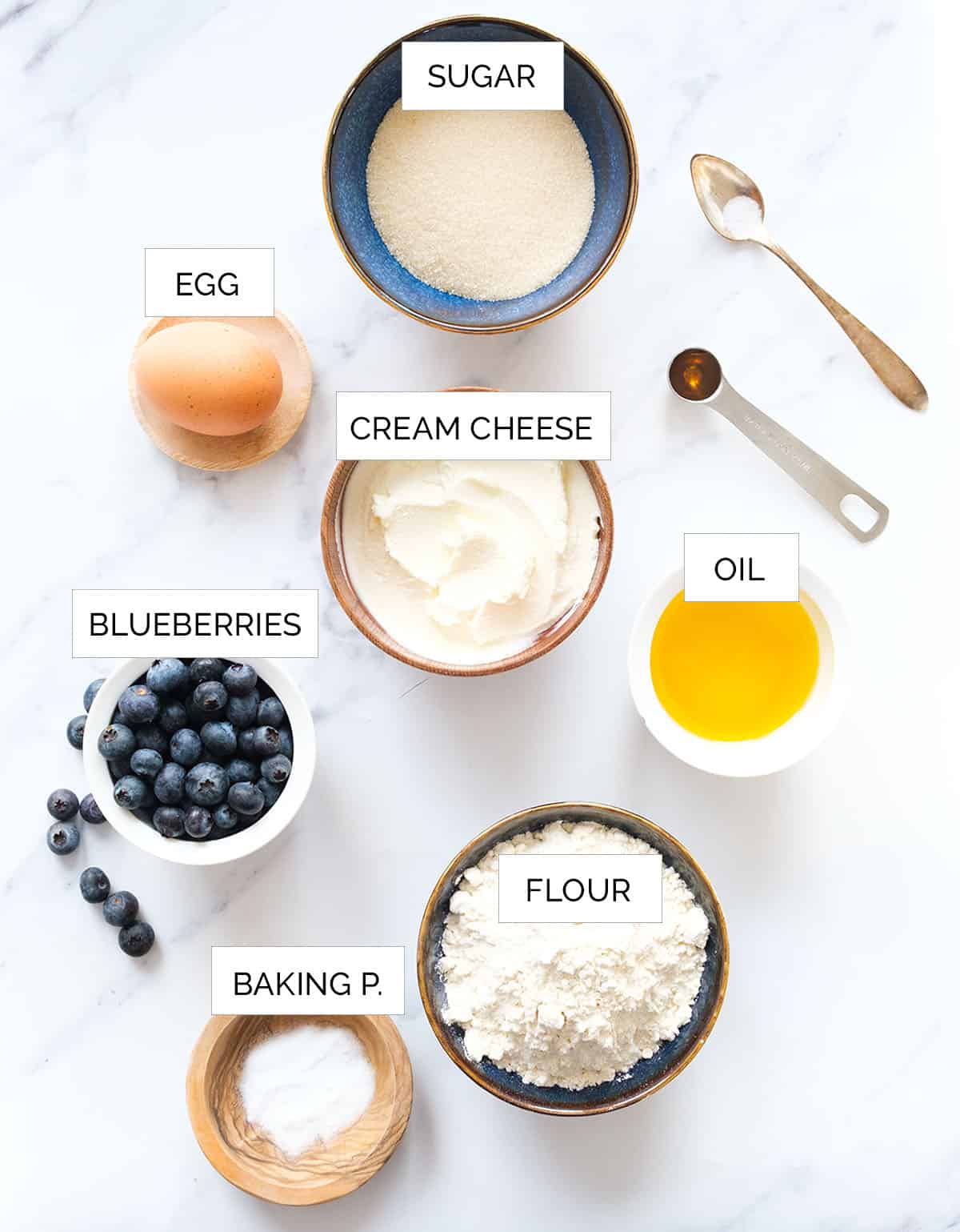 The ingredients to make these cream cheese blueberry are arranged over a white background.