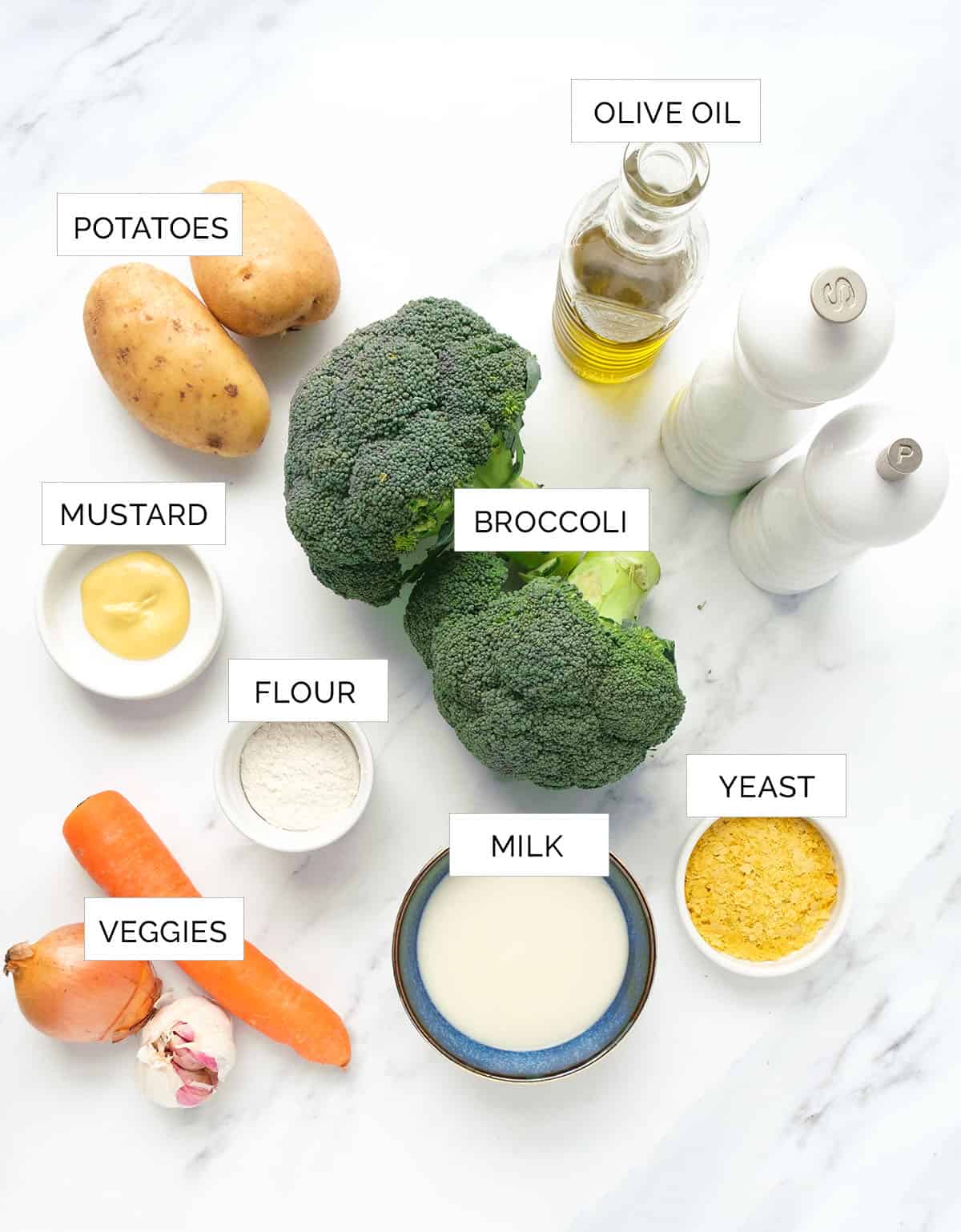 The ingredients to make this vegan broccoli soup are arrange over a white background.