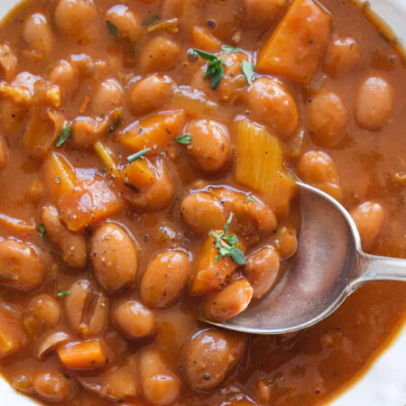 Top view of a white bowl full of bean stew, a delicious bean recipes.