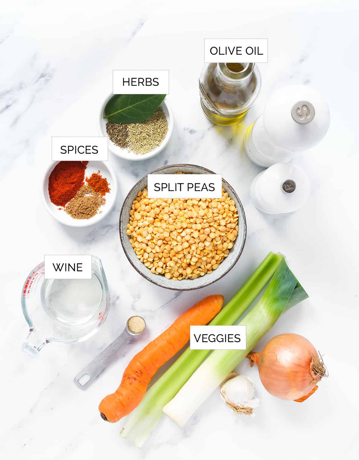 The ingredients to make this vegan split pea soup are arranged over a white background.