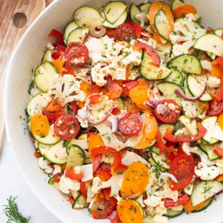 Marinated vegetable salad in a white salad bowl.