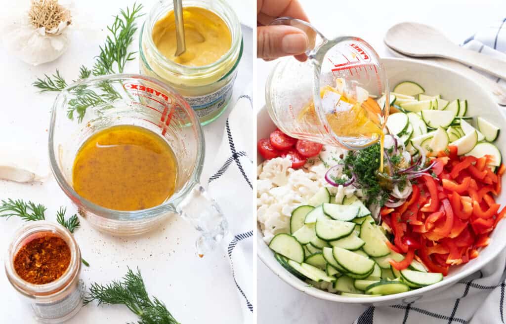 A glass jug pouring dressing over a vegetable salad.