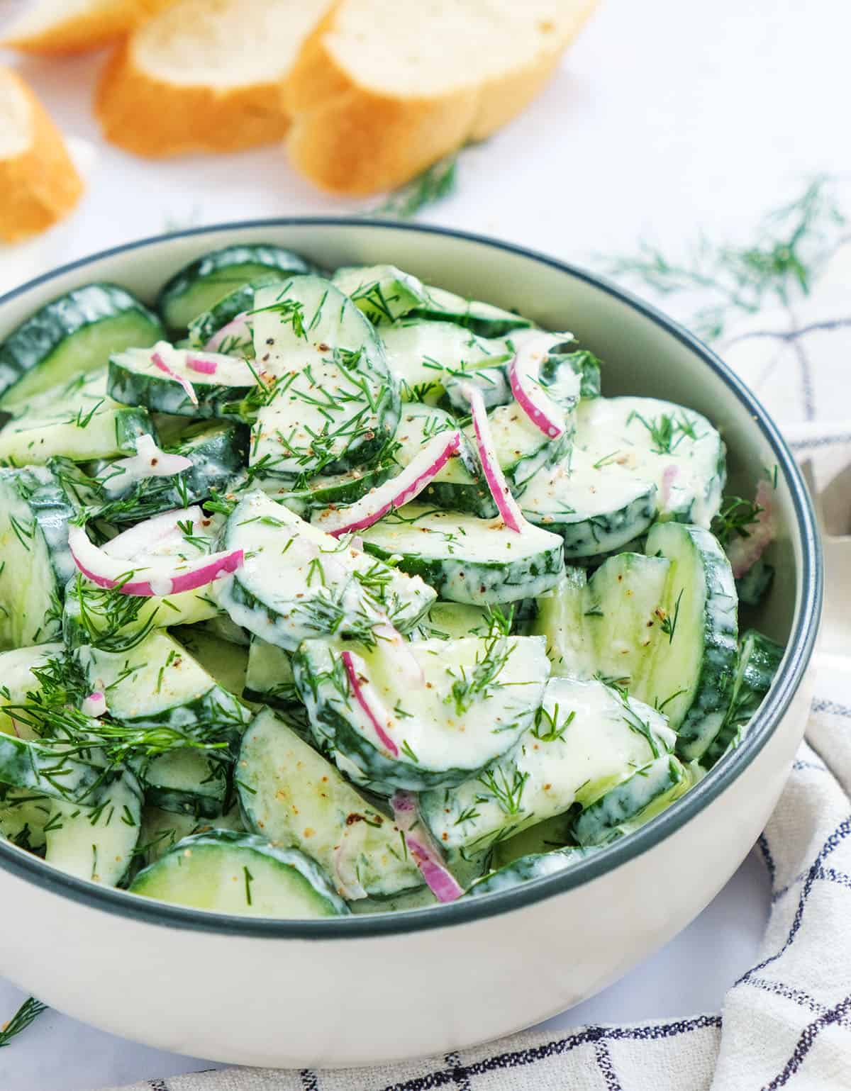 Close-up of a bowl full of cucumber dill salad.