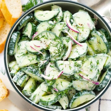 Top view of a bowl full of cucumber dill salad.