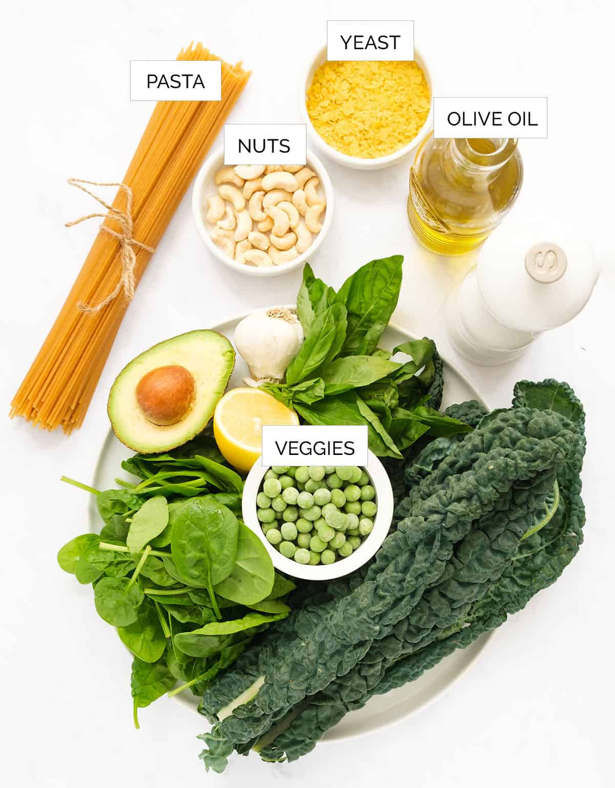 The ingredients to make this healthy spaghetti are arranged over a white background.