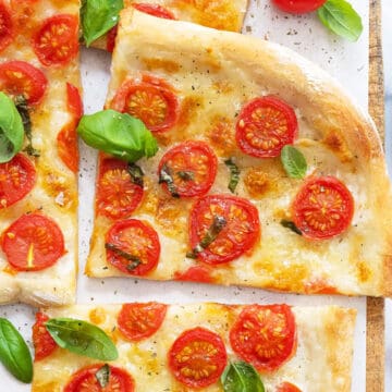 Top view of a soft focaccia with cherry tomatoes.