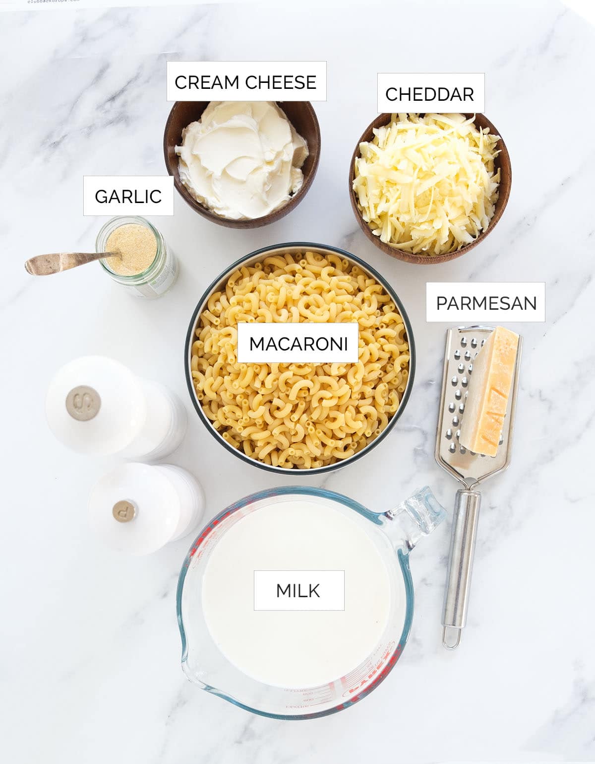 The ingredients to make this one pot mac and cheese are arranged over a white background.