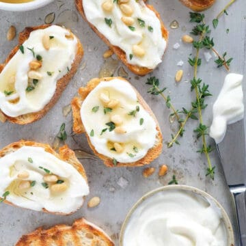 Top view of crostini topped with whipped ricotta.