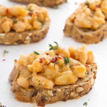 Close-up of some beans on toast over a white background.