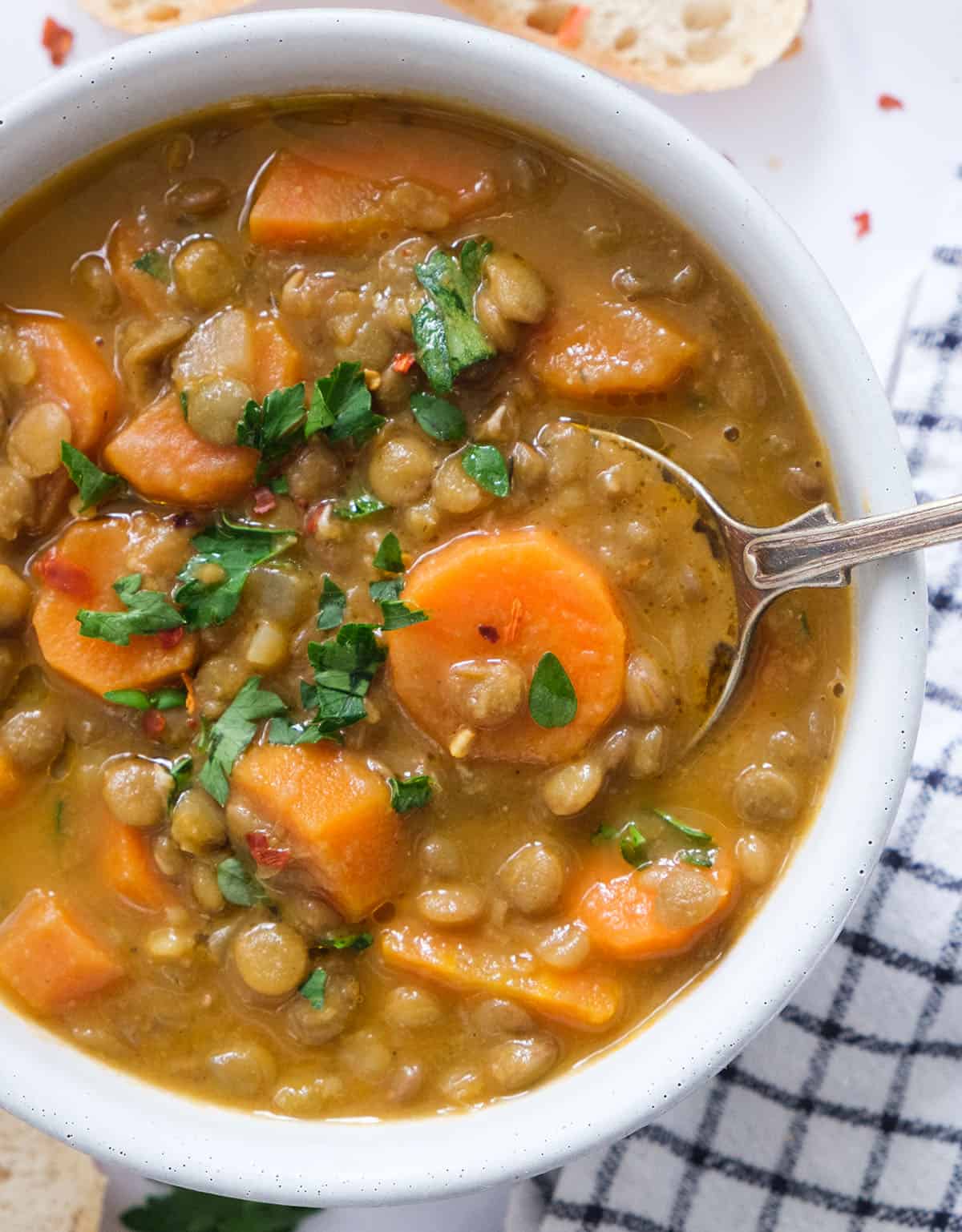 Close-up of a bowl full of carrot lentil soup.