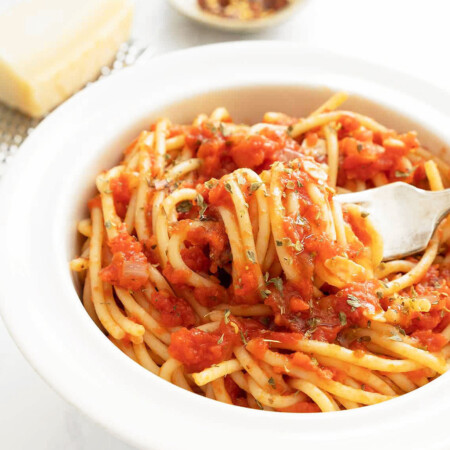A white bowl full of spaghetti marinara, one of the most popular spaghetti sauce recipes.