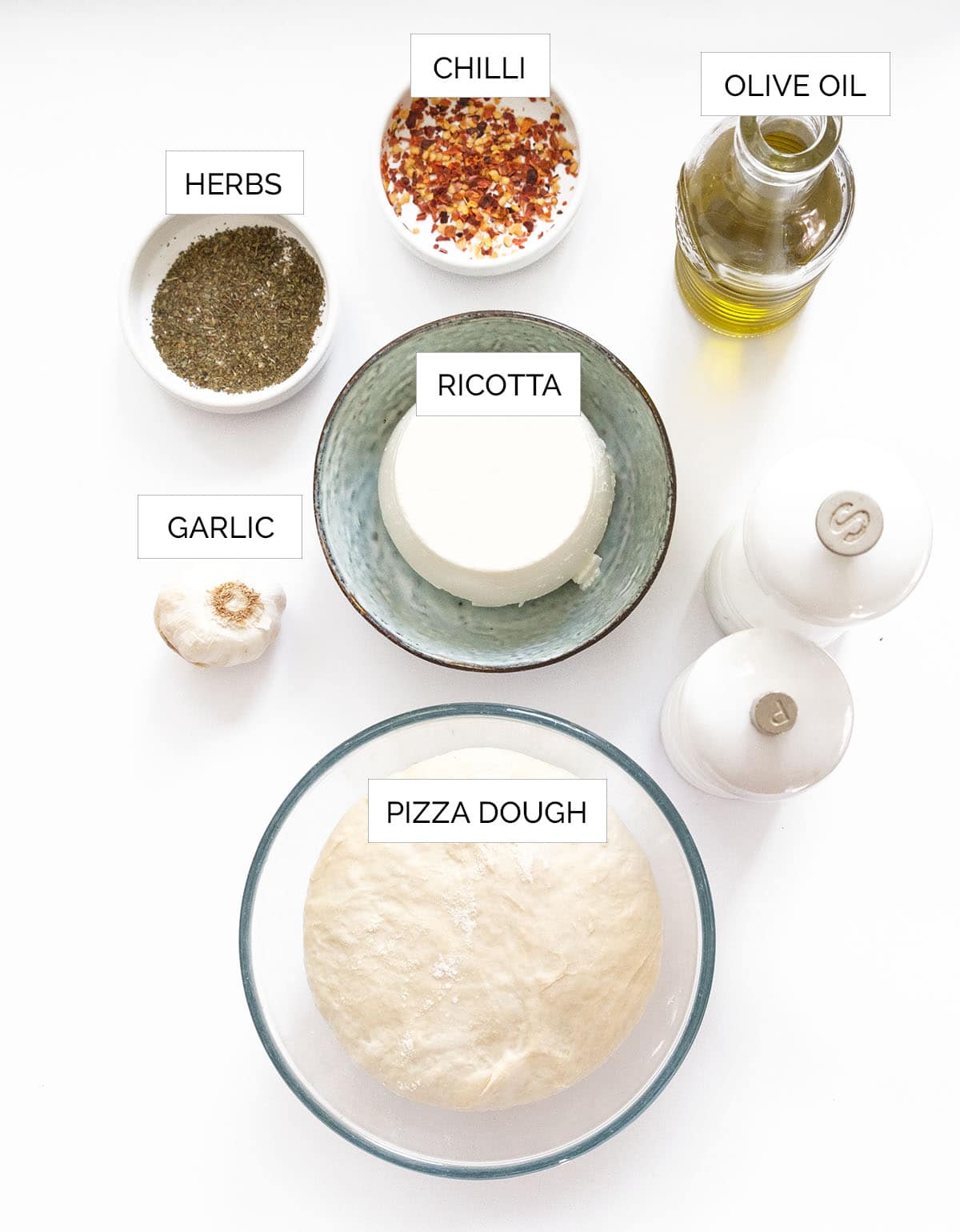 The ingredients to make ricotta pizza are arranged over a white background.