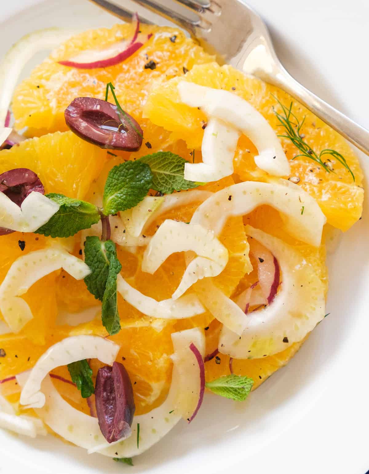 Close-up of a serving of juicy and bright orange salad.