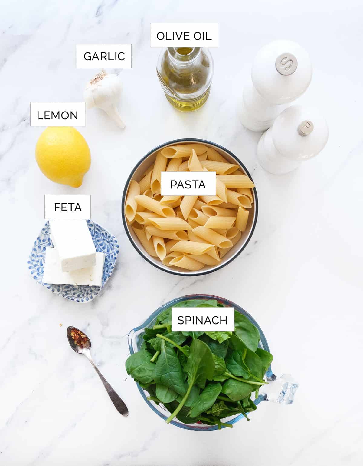 Top view of the ingredients to make spinach feta pasta.