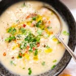Close-up of a black bowl full of creamy bean soup.