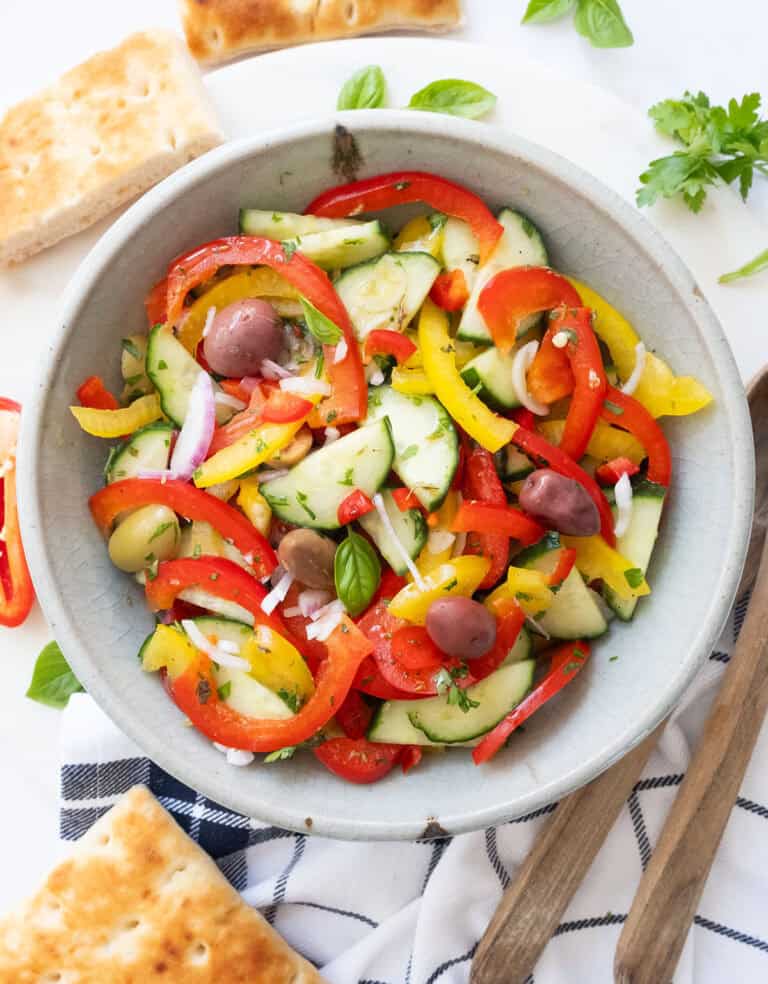 Peppers cucumber salad in a grey bowl.