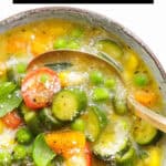 A bowl full of summer soup with vegetables.