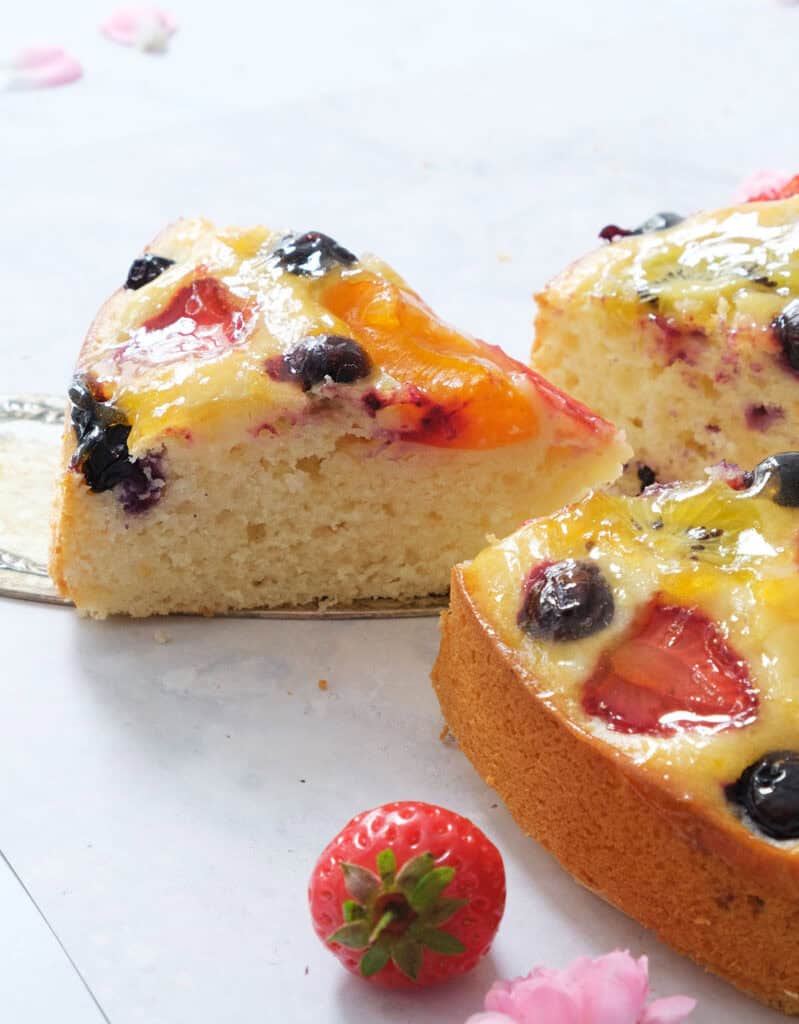 A slice of fruit cake over a white background.