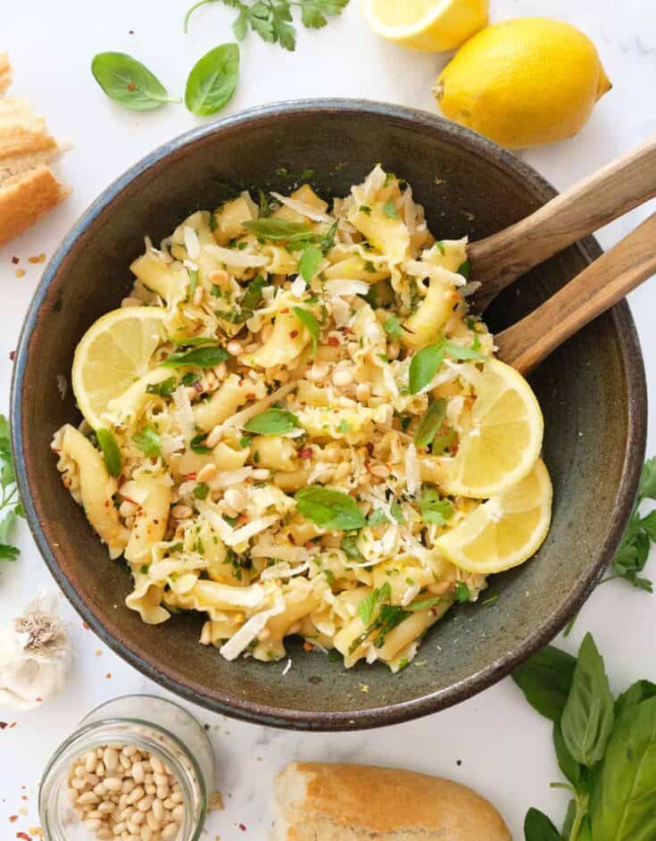 Top view of a brown bowl full of lemon pasta salad.
