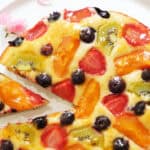 Top view of a colorful fruit cake over a white background.