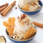 Close-up of two blue bowls with apple ice cream.