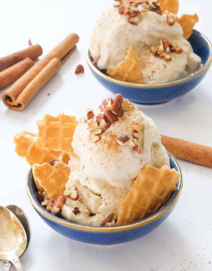 Close-up of two blue bowls with apple ice cream.