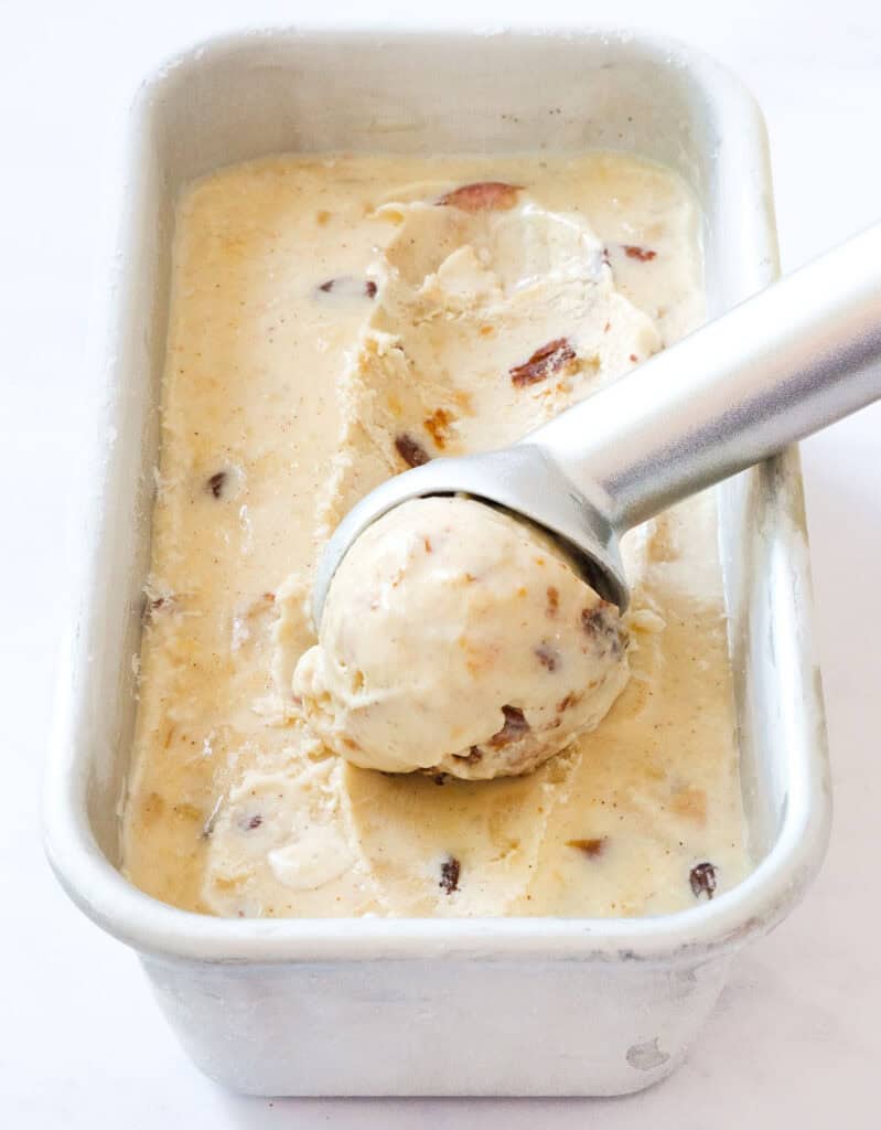 A container with creamy, scoopable apple ice cream.