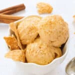 A white bowl full of pumpkin ice cream.