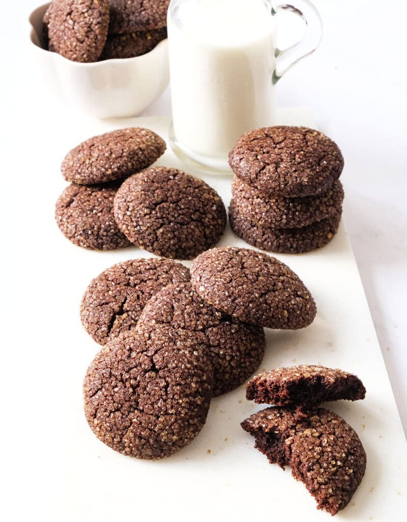 Cocoa cookies with a bottle of milk over a white background.