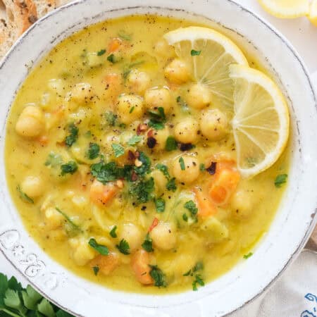 Top view of a white bowl full of lemon chickpea soup.