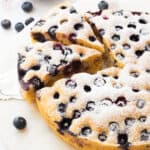 A blueberry ricotta cake cut into slices.