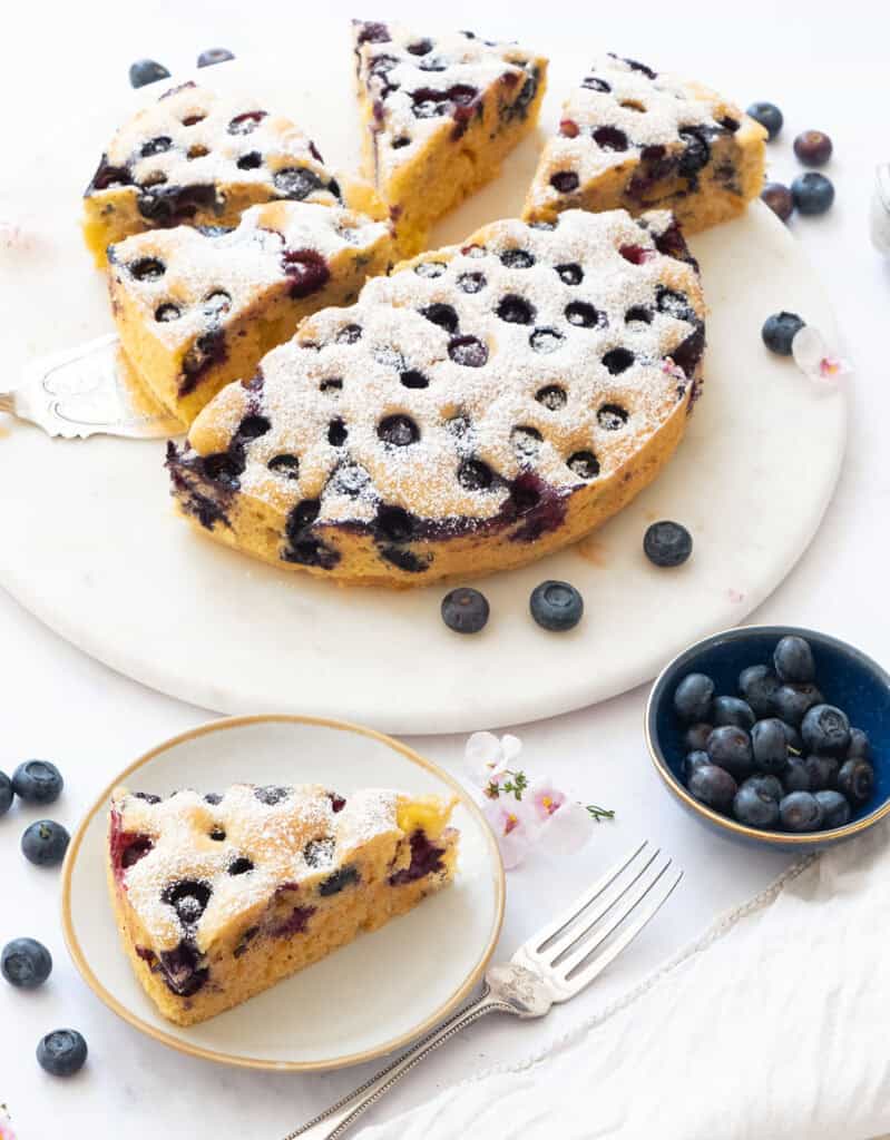 A ricotta blueberry cake cut into slices.