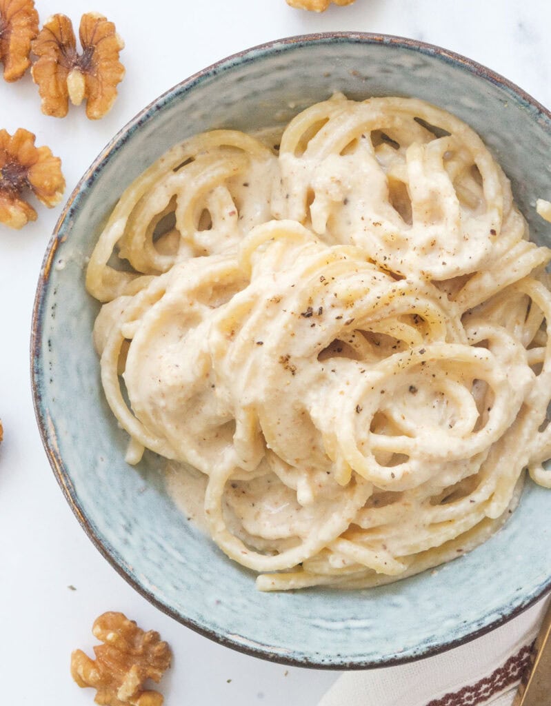 Top view of a bowl full of walnut pesto pasta.