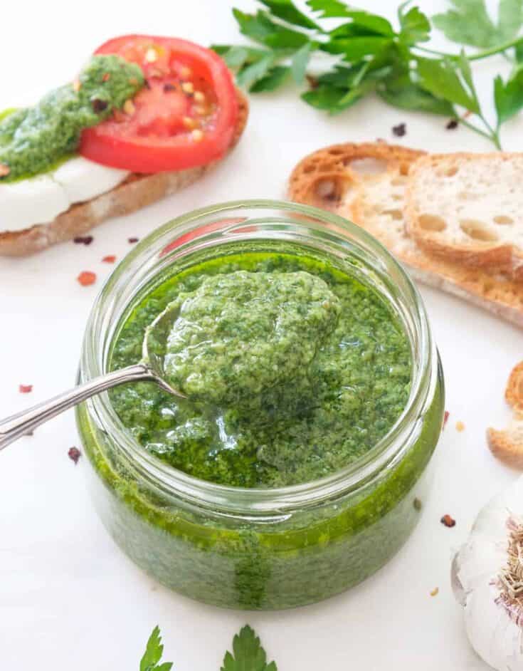 A glass jar full of Italian salsa verde.