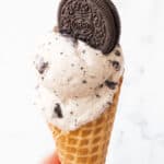 Close-up of oreo ice cream on a cone.