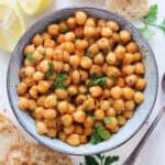 Top view of sauteed chickpeas in a blue bowl.