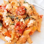 Tomato ricotta pasta on a white plate.