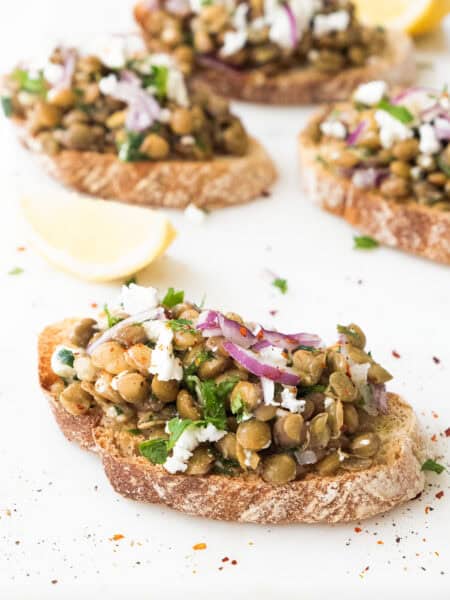 Lentil bruschetta on a white background.
