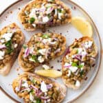 A plate full of lentil bruschetta.