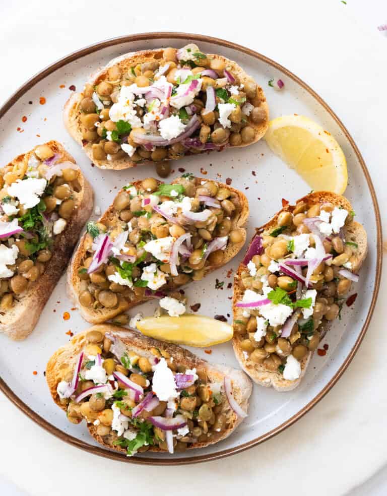 A plate full of green lentil bruschetta.