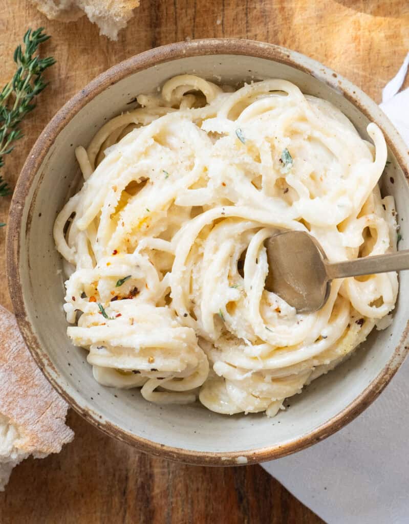 Top view of a bowl full of creamy goat cheese pasta.
